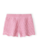 Pink crochet knit shorts for girls with a delicate scalloped hem and intricate design pattern.