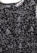 Close-up of black fabric with white floral print showcasing unique design and texture in kids fashion pullover.