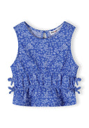 Blue floral sleeveless girls top with loose fit and side tie details showcasing a playful and comfortable design.