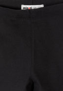 Close-up of black cycling shorts fabric and elasticated waistband design for kids fashion by Minoti