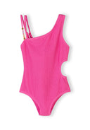 Bright pink asymmetrical girls swimsuit with textured fabric and cut-out waist detail, featuring double shoulder straps with beads.