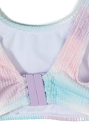 Close-up of elasticated tie-dye fabric with pastel pink and blue colors and a purple adjustable clasp design