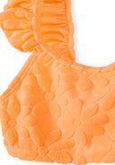 Close-up of girls neon orange bikini top with floral jacquard texture and ruffle trim design details