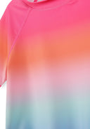 Close-up of a girls rash top with a pink, orange, and blue ombre design showcasing smooth fabric and stitching details.