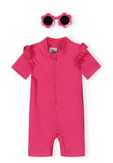 Pink short sleeve girls rash suit with ruffle details and matching flower-shaped sunglasses for sun protection.