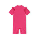 Girls pink short sleeve rash suit with ruffled shoulders and textured fabric, back view.