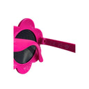 Close-up of pink flower-shaped sunglasses with dark lenses and "CE UK CA" markings on the arm.