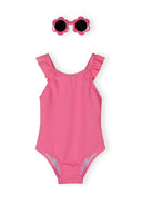 Pink one-piece swimsuit for girls with frill details on straps paired with flower-shaped pink sunglasses
