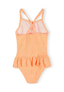 Girls neon orange swimsuit with jacquard floral design, ruffle waist, and crossed shoulder straps for toddlers and young kids