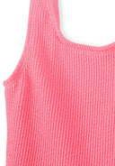 Close-up of textured pink sleeveless fabric with a unique ribbed design for girls' swimsuit fashion.