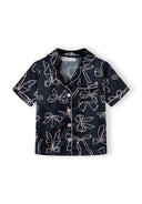 Navy satin button-front girls’ top with unique bow line print design for kids’ fashion and comfort.