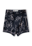 Girls satin pajama shorts in navy with a delicate bow print design, featuring a comfortable elastic waistband.