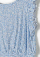 Light blue floral fabric with ruffled sleeve detail and gathered elastic waist design for girls' clothing.