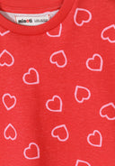 Close-up of a red cotton t-shirt with a unique pink heart print design for kids aged 3-7 years.
