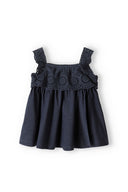 Girls broderie frill top in navy blue, lightweight fabric with decorative shoulder straps, size 3m-3y.
