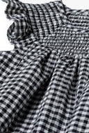 Girls smock dress frilled sleeves grey 3m-3y features soft woven monochrome grey gingham pattern and shirred neckline. 