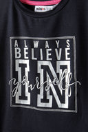 Girls cropped oversized top black 3-14y with motivational text print in silver on soft, lightweight fabric. Comfortably relaxed design.