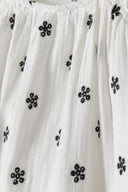 Girls embroidered dress with frilled straps white 1-8y featuring delicate black floral embroidery on a lightweight white fabric.