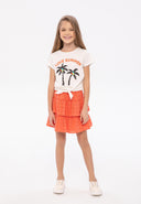 Girls skirt broderie anglaise tiered coral 1-8y featuring lightweight fabric, frill hems, and an elastic waistband.