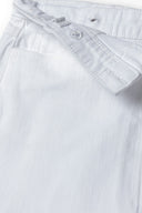 Girls twill skirt asymmetric hem white 3-14y featuring off-centre fastening and silver shank buttons, crafted from durable twill fabric.