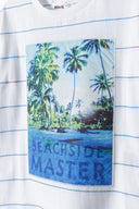 Boys t-shirt photo print applique white 3-14y with a beachside scene and blue striped detailing. Comfortable lightweight fabric.