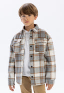 Boy in gray beige plaid flannel padded shirt jacket with black buttons