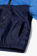 Boys windbreaker coat in navy blue and bright blue two-tone nylon with striped sleeves