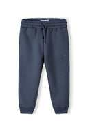 Girls fleece jogpant in blue with heart embroidery, dark gray drawstring waistband and ribbed cuffs