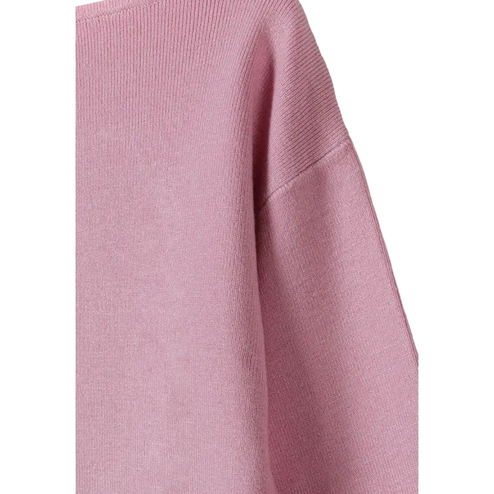 Close-up detail of pink textured knit fabric showing sleeve construction and knit pattern texture