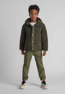 Boys woven cargo trousers elastic waist khaki 2-14y with elastic waistband, side cargo pockets, paired with a cozy olive green jacket. 